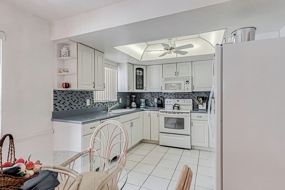 Your fully equipped kitchen awaits with modern appliances, stylish tile backsplash, and everything needed to prepare your favorite meals during your stay.