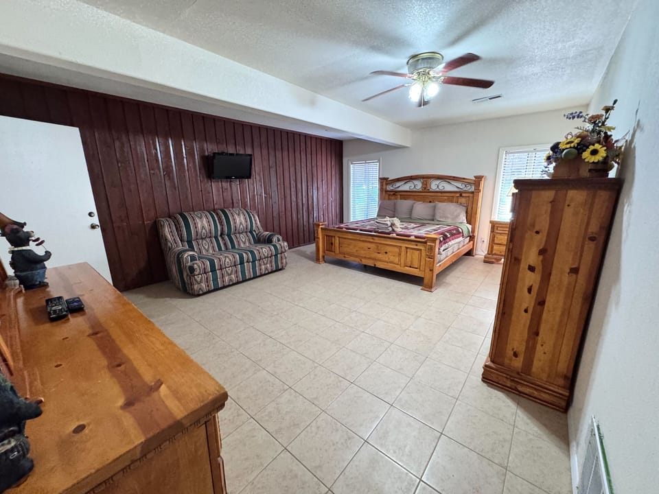 Comfortable king bed with fresh linens and views of the trees.