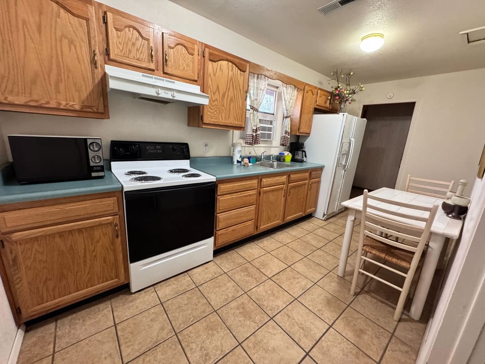 Compact full kitchen stocked with everything you need to cook in.