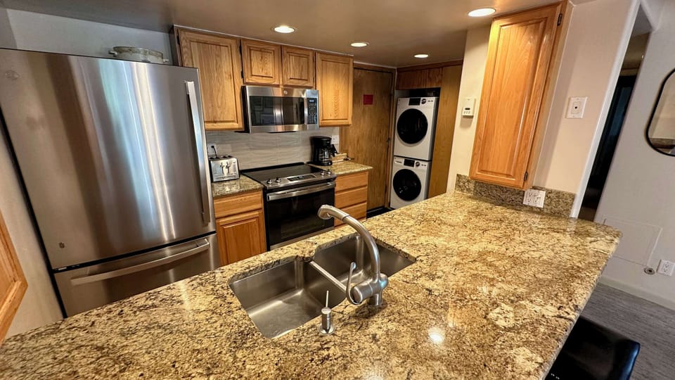 Kitchen and washer dryer in entry way
