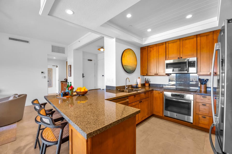 Cook with ease in a spacious kitchen featuring stainless appliances and ample counter space.