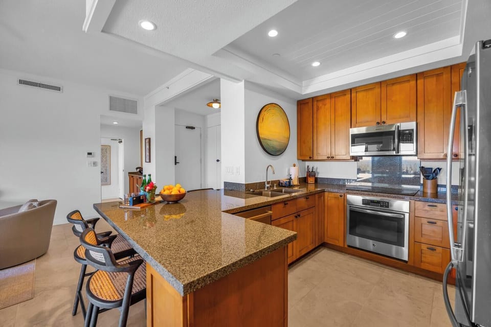Cook with ease in a spacious kitchen featuring stainless appliances and ample counter space.