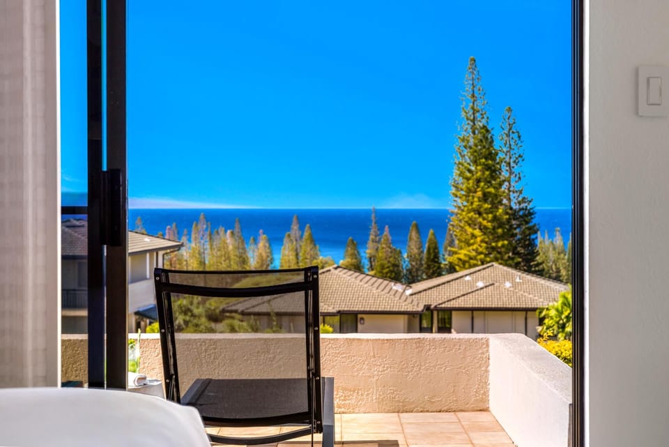 A seating area just outside the primary bedroom captures relaxing ocean views.