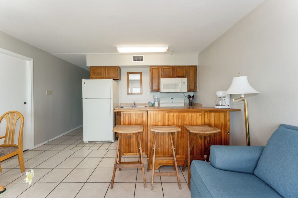 Our tiny living space packs a big punch! The endless beachfront view pairs perfectly with our simple kitchen and dining space.