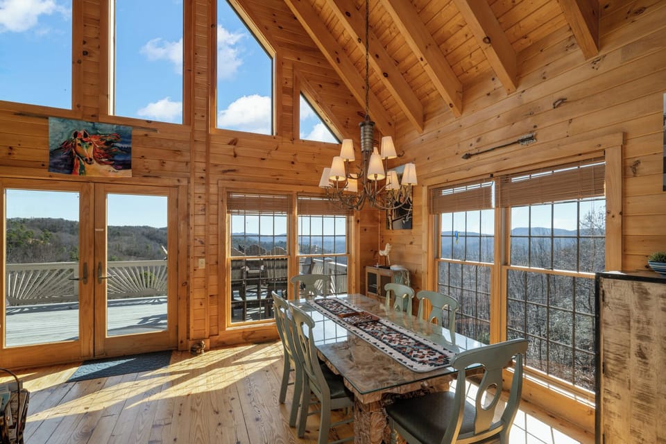 Warm wood surrounds you as natural light floods this dining space, where mountain views frame every meal through floor-to-ceiling windows.