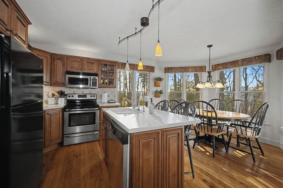 Your spacious kitchen and dining area features rich wood cabinets, modern appliances, and a welcoming table for memorable meals together.