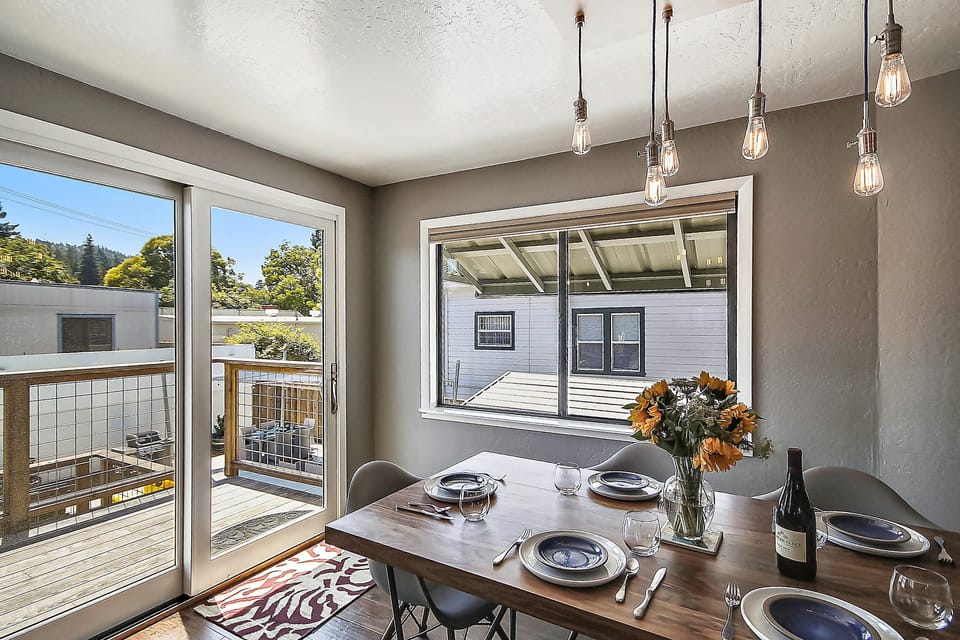 Light and bright dining space opens to the back stairs and overlooks the pool.