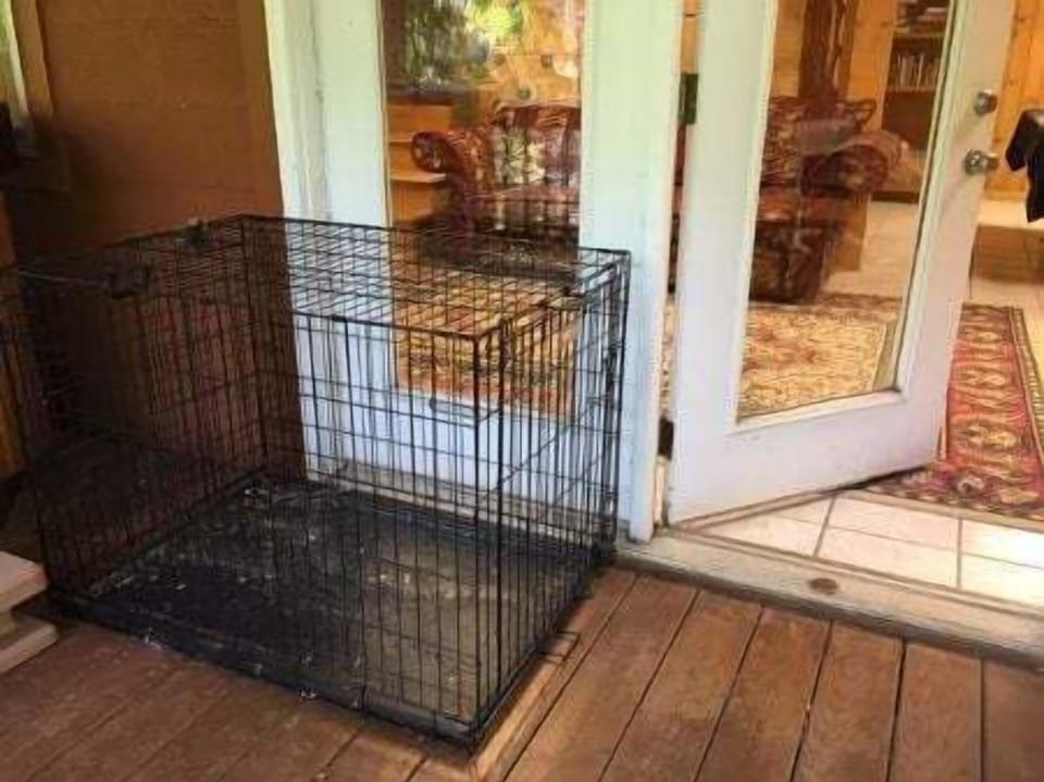 Large dog crate on lower covered deck