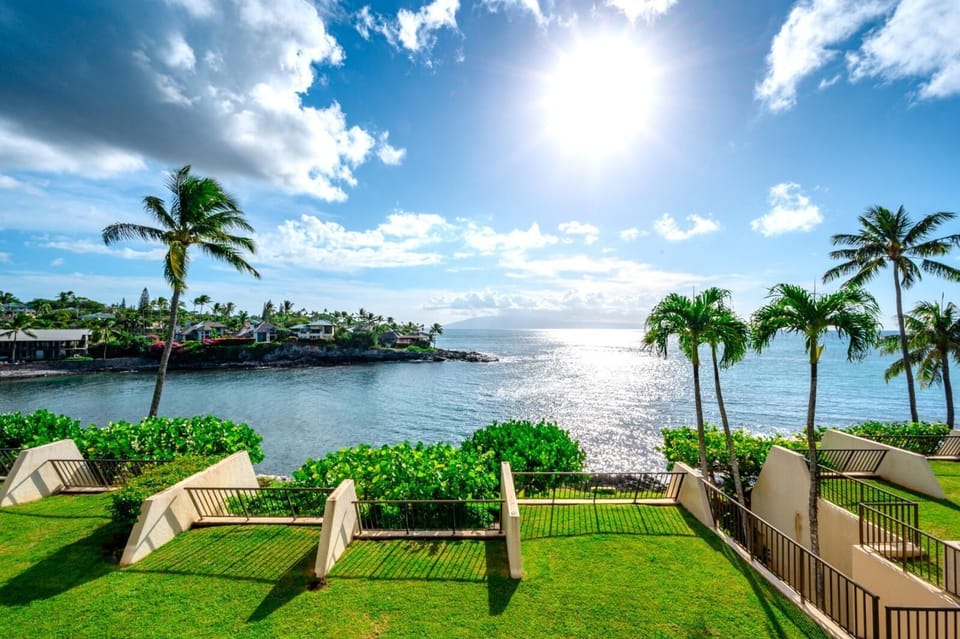 Soak in the morning sun from your lanai, ocean sparkling, palms swaying, and paradise just beyond reach