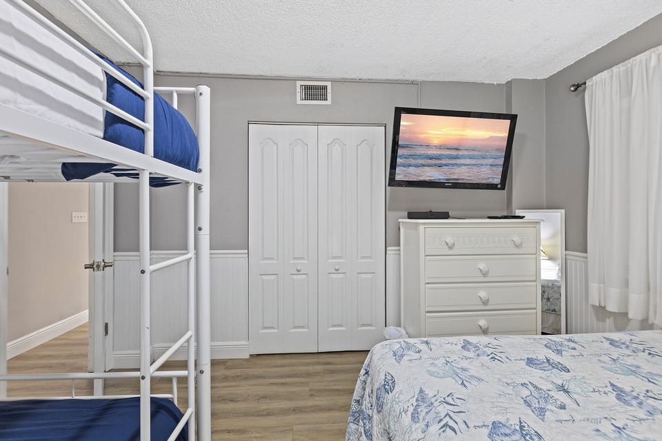 Bunk room with flat screen TV