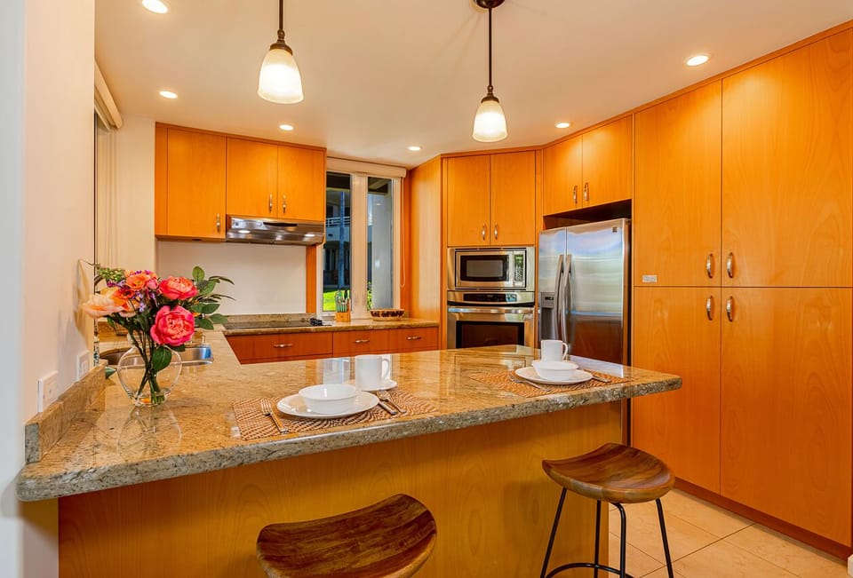 Kitchen features a spacious breakfast bar with seating for two.