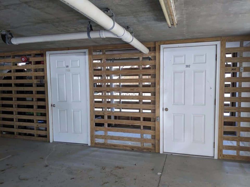 Parking area on ground floor of building. Parking for a maximum of 2 average sized vehicles. 
Closets pictured house beach items gifted by owners.