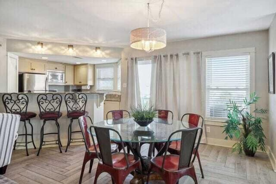 the dining table and door to balcony just beyond.