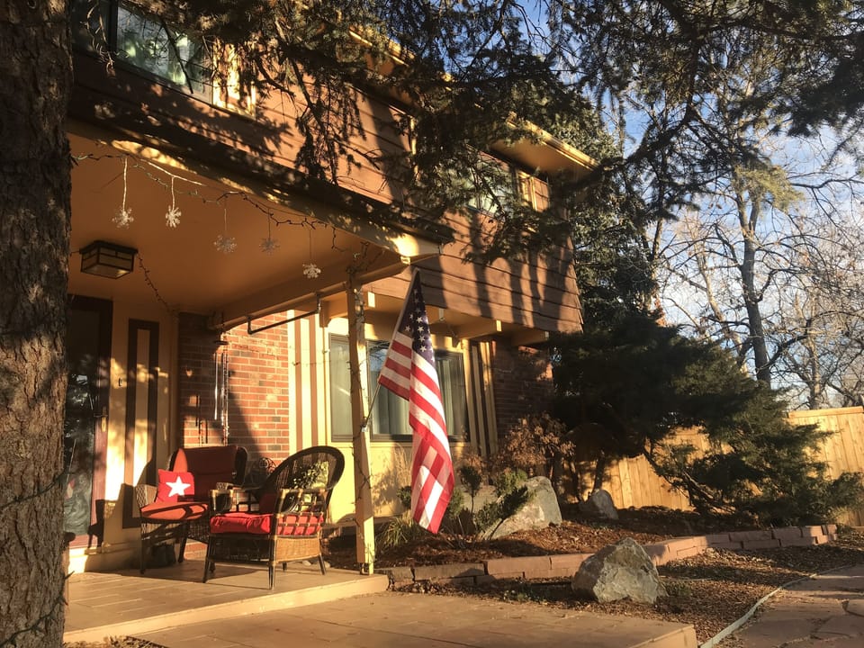 Front porch in sunlight makes an excellent outdoor gathering area for relaxing.