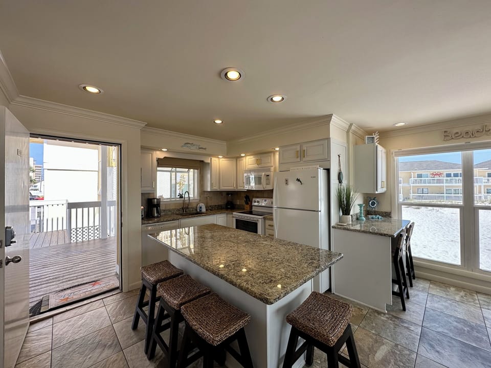 Your gourmet kitchen features granite countertops, modern appliances, and a breakfast bar perfect for morning coffee while enjoying stunning water views.