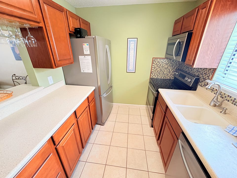 Your fully equipped kitchen features warm wood cabinetry, stainless appliances, and everything you need to prepare delicious meals during your stay.