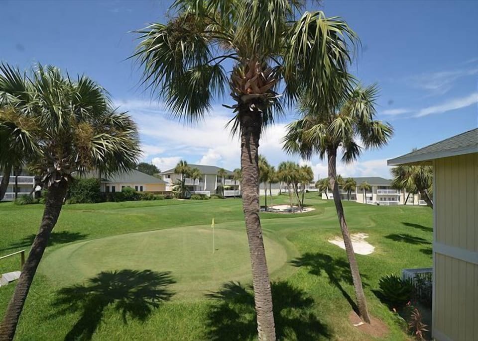 A tropical paradise with swaying palms and manicured putting green right outside your door.