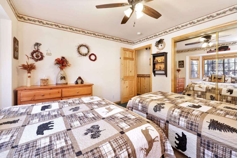 Peaceful cabin bedroom with plush bedding, and beautiful views—ideal for restful nights, cozy mornings, and a relaxing mountain escape.