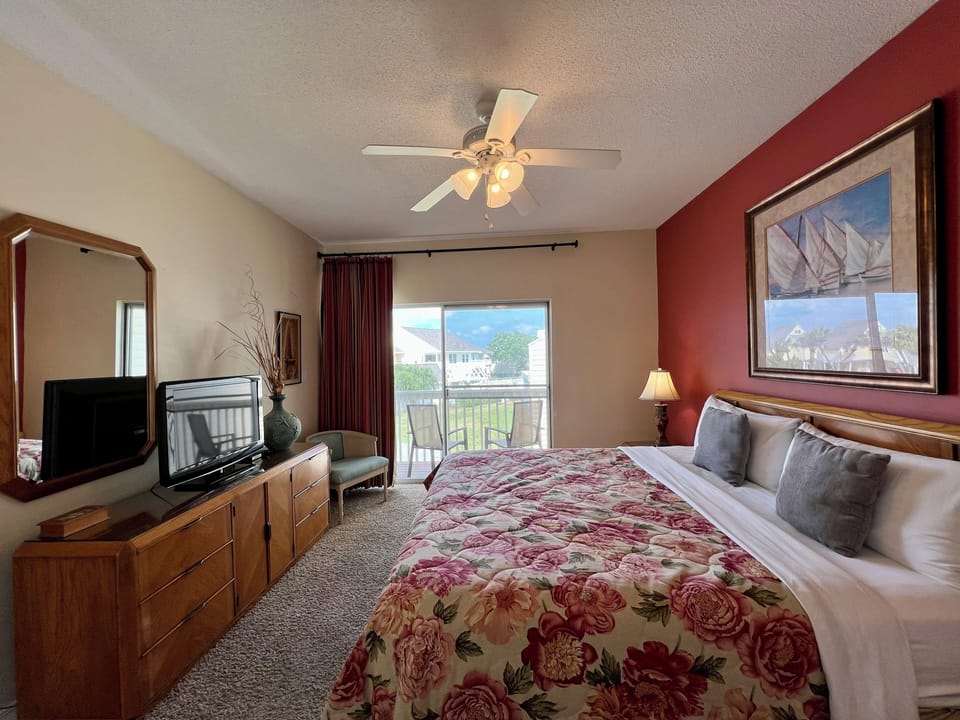 Rest peacefully in your comfortable bedroom with warm décor, ceiling fan, and balcony access for fresh air.