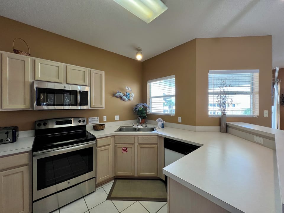 Cook your favorite meals in this fully-equipped kitchen with stainless steel appliances, ample counter space, and natural light streaming through bright windows.