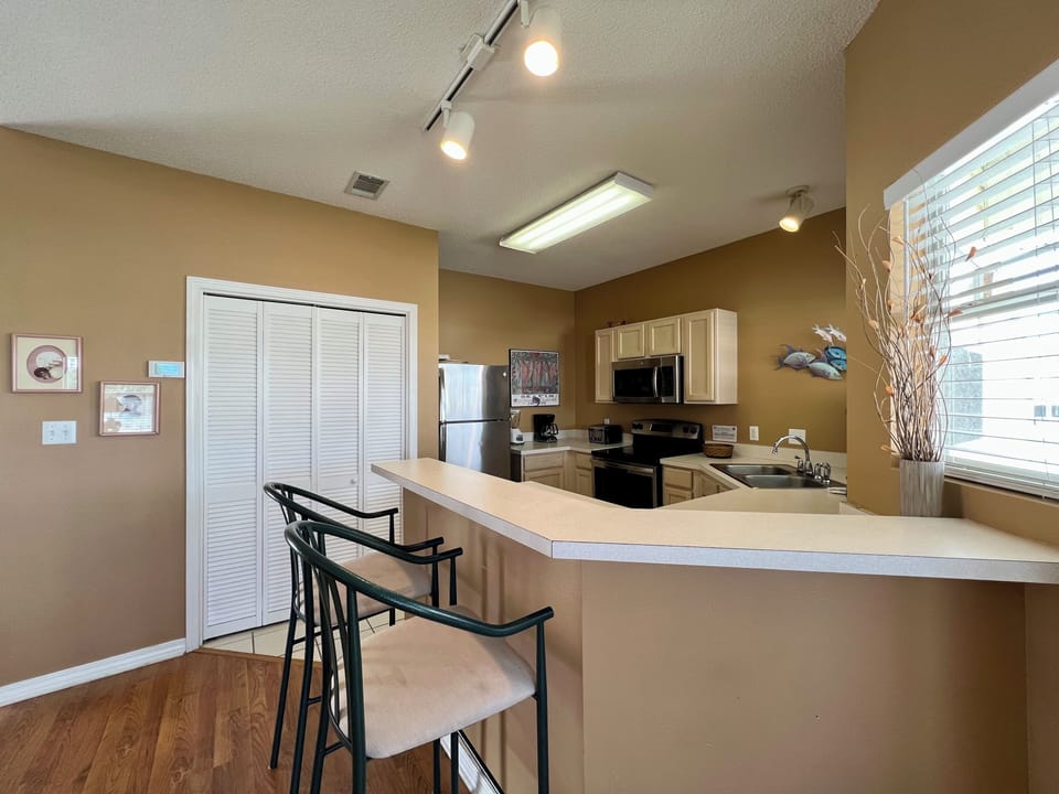 Your fully-equipped kitchen features modern appliances and a breakfast bar where you can enjoy morning coffee with city views.