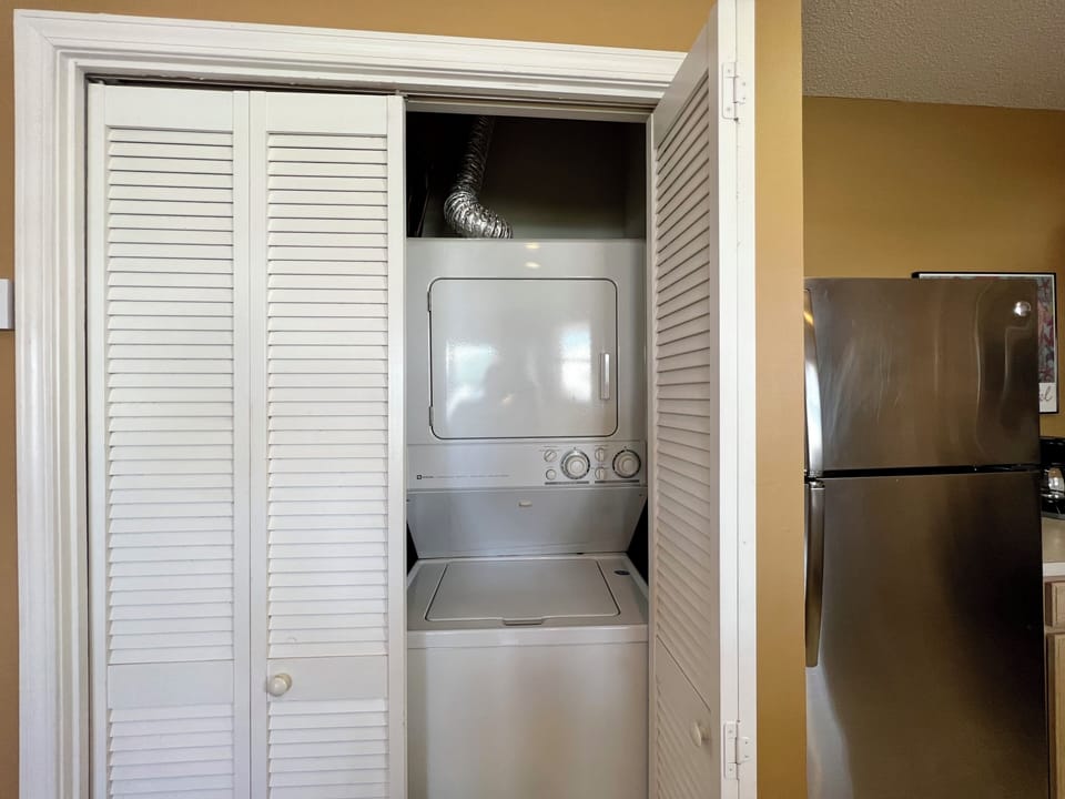 Your in-unit laundry closet features a convenient stacked washer and dryer, keeping your clothes fresh throughout your stay.