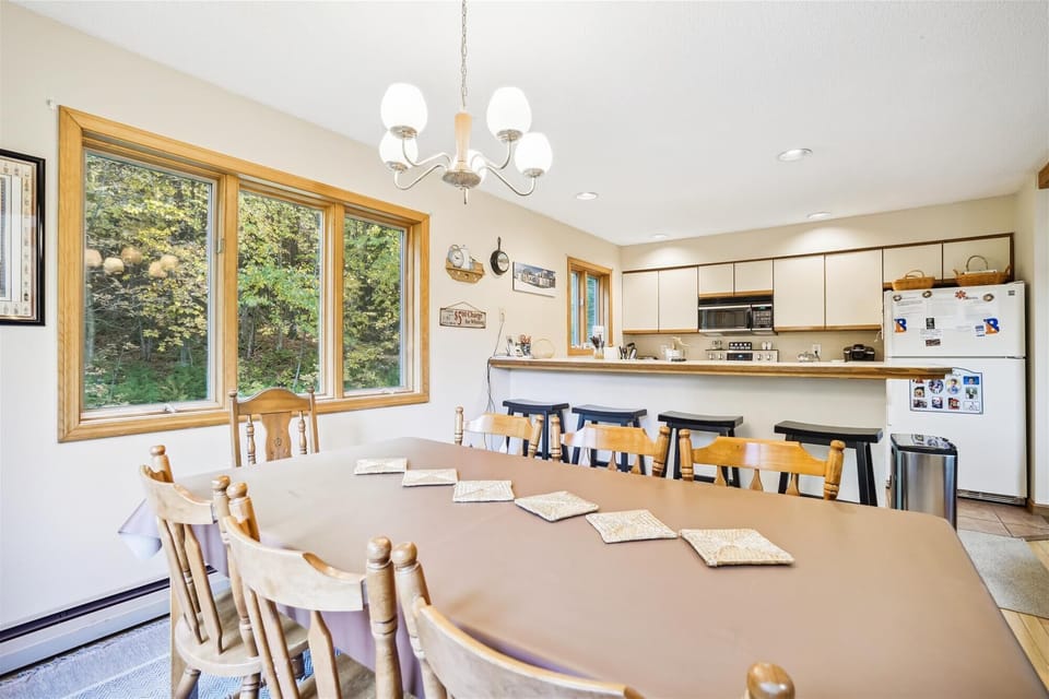 Dining table seats 8 comfortably, lots of natural light and large windows to enjoy the surrounding nature while have a home cooked meal.  Extra seating at the breakfast nook.