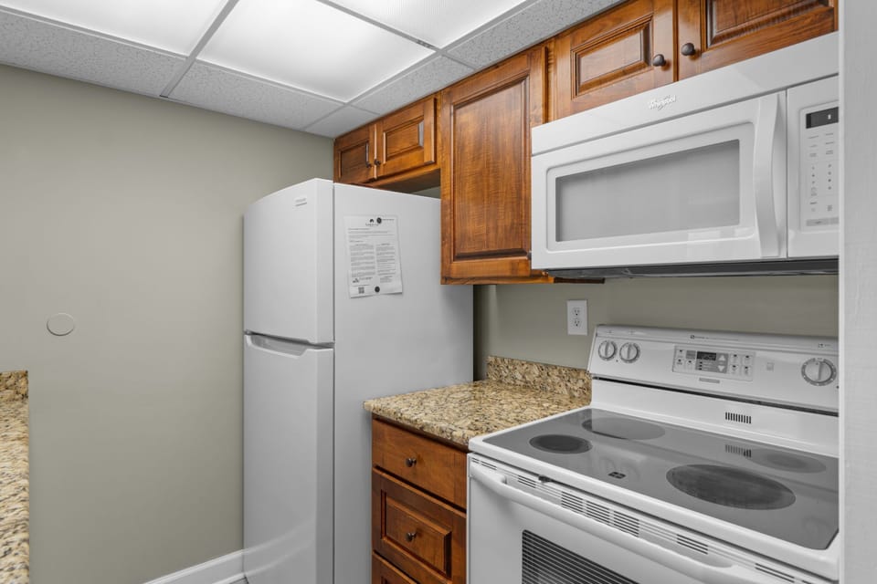 Your kitchen is fully equipped with everything needed for meal prep—full fridge, microwave, stove, and plenty of cabinet space to feel at home during your stay.