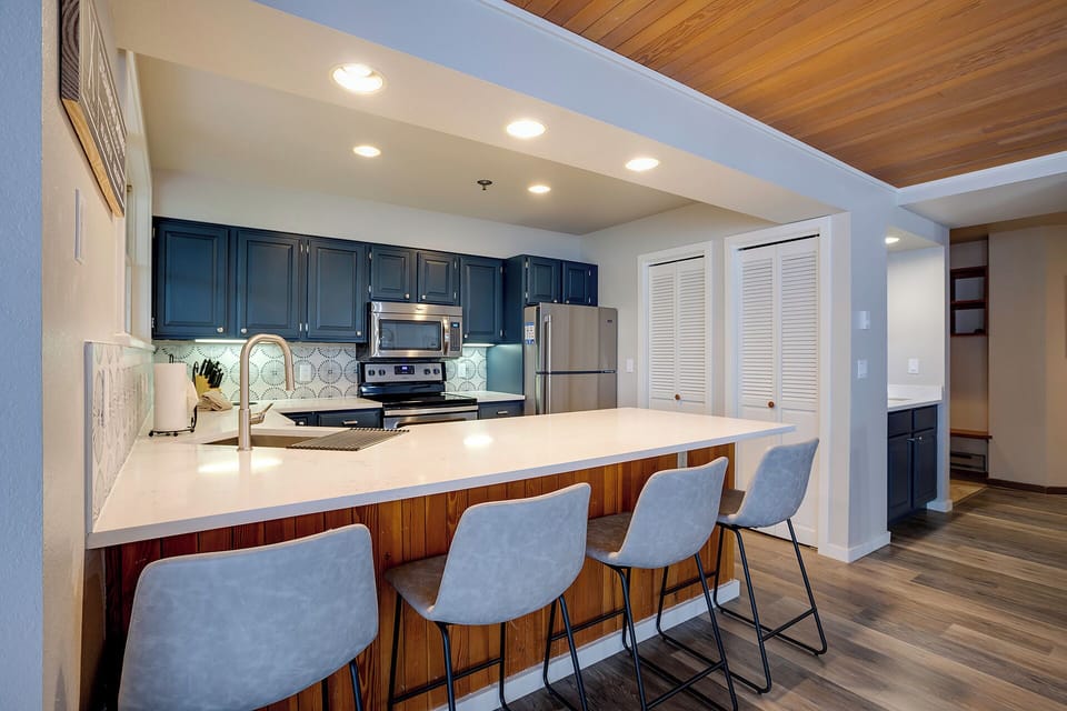 Your sleek kitchen invites culinary adventures with modern appliances, spacious countertops, and comfortable bar seating for memorable meals together.