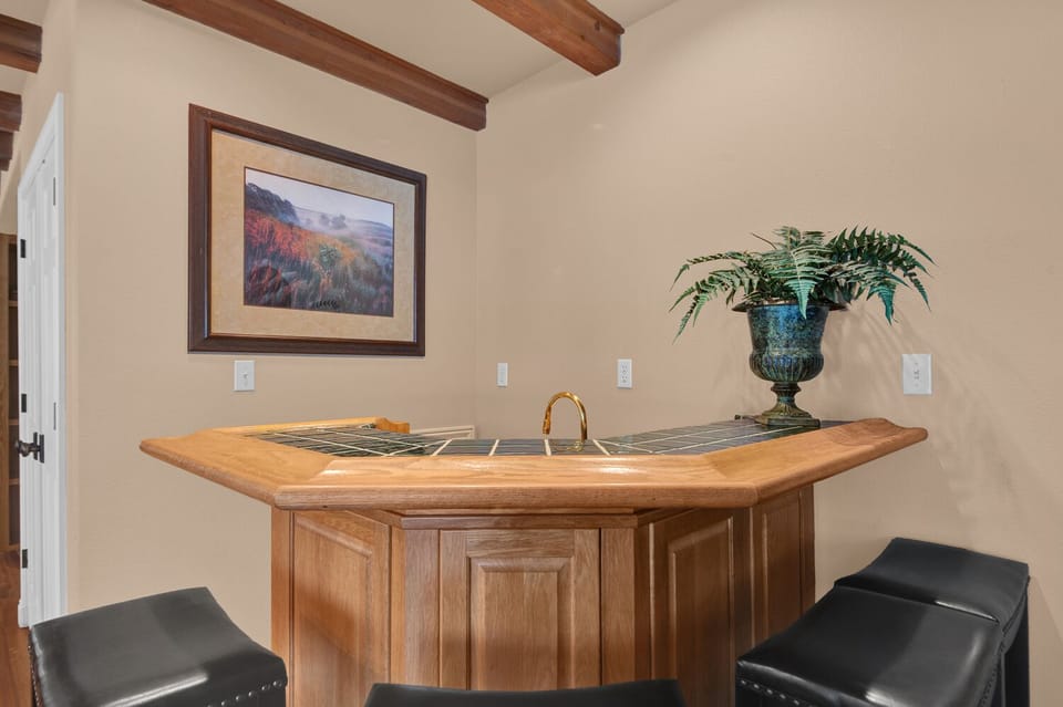 The bar has 4 seats and a mini fridge for the bar keep in your party.