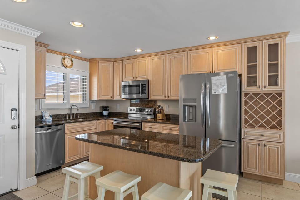 Your spacious kitchen features granite countertops, stainless steel appliances, and ample cabinet storage for comfortable meal prep.