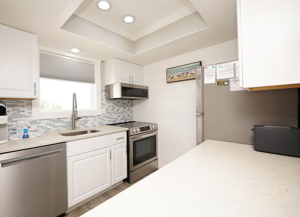 Your bright, modern kitchen awaits with everything needed to create memorable meals during your stay.