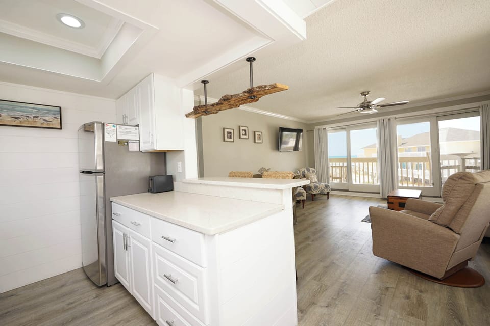 You'll love this open-concept space where your kitchen flows into your comfortable living area, perfect for coastal relaxation.