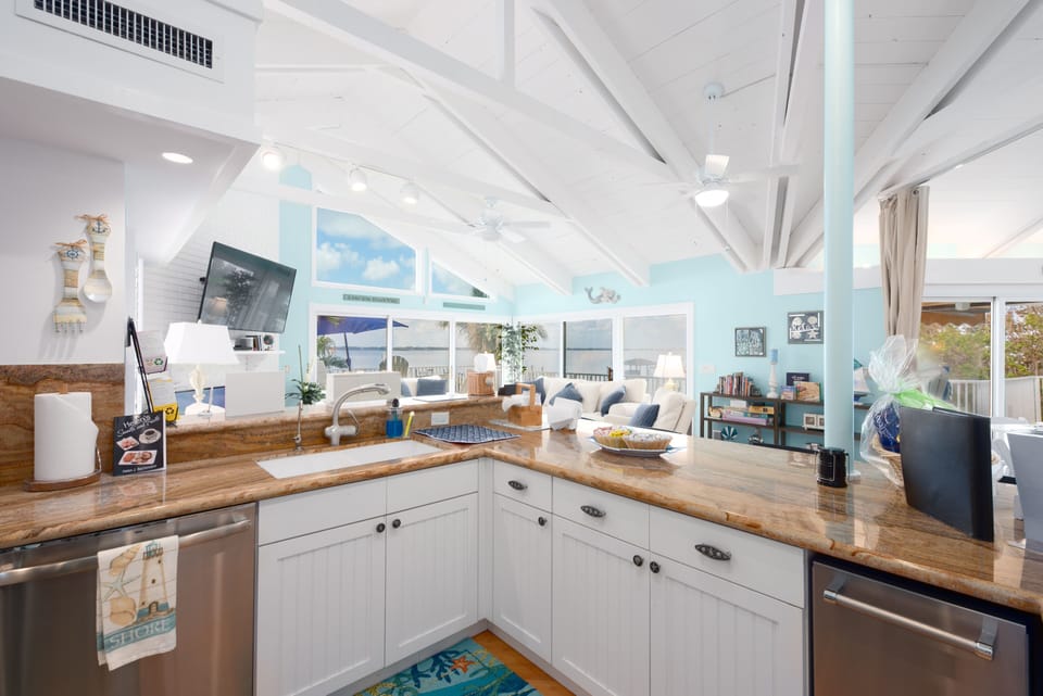 Kitchen with raised breakfast bar and granite countertops