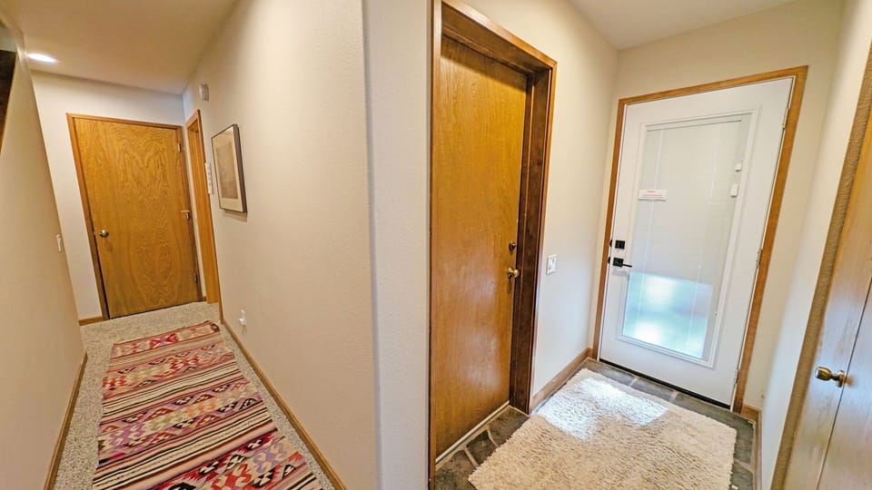 White Door leads to the Hot Tub, Other door to Garage