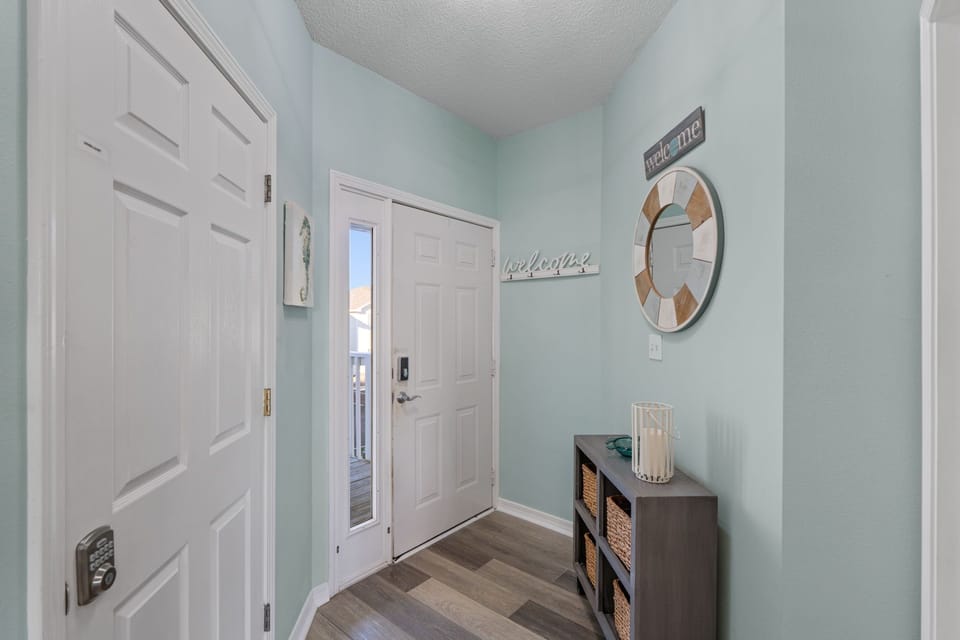 Step into your welcoming entrance, where coastal mint walls and nautical touches set the perfect vacation mood from the moment you arrive.