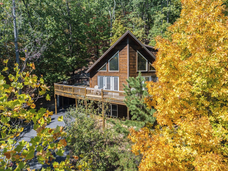 A frame log home with wrap around deck for wonderful slope and forest views