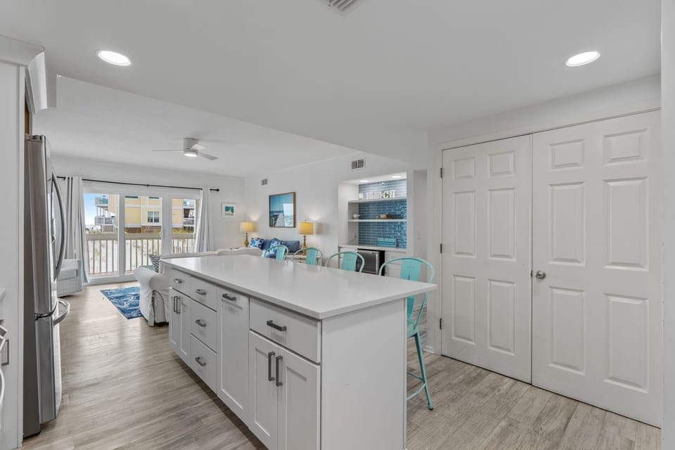 Your spacious kitchen island becomes the heart of your stay, perfect for morning coffee or evening meals with coastal views.