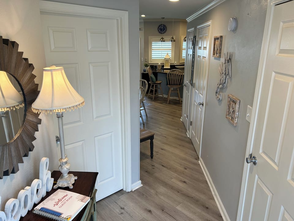 Step into your welcoming hallway where thoughtful details and warm lighting guide you toward the heart of your home away from home.