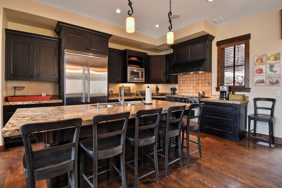 Your gourmet kitchen features granite countertops, stainless steel appliances, and a spacious island perfect for cooking memorable meals together.