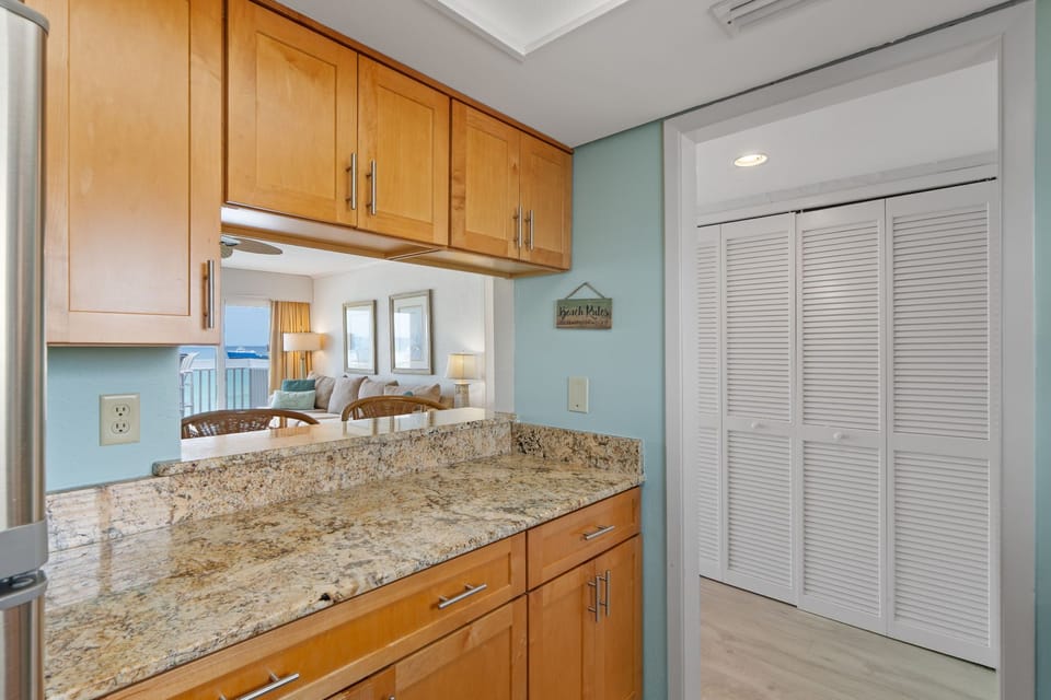 Your granite-topped kitchen offers everything you need to prepare meals while staying connected to the bright living space beyond.