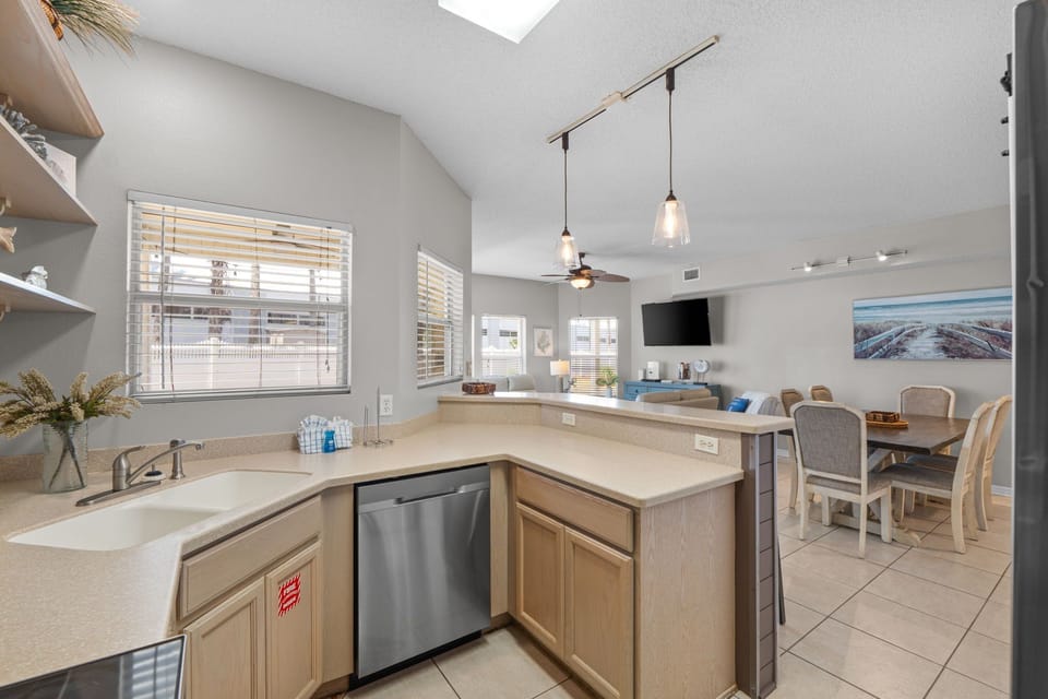Step into your bright, open-plan living space with soaring ceilings and a skylight that fills the room with natural light. The fully equipped kitchen flows seamlessly into the dining and lounge areas—perfect for gathering together.