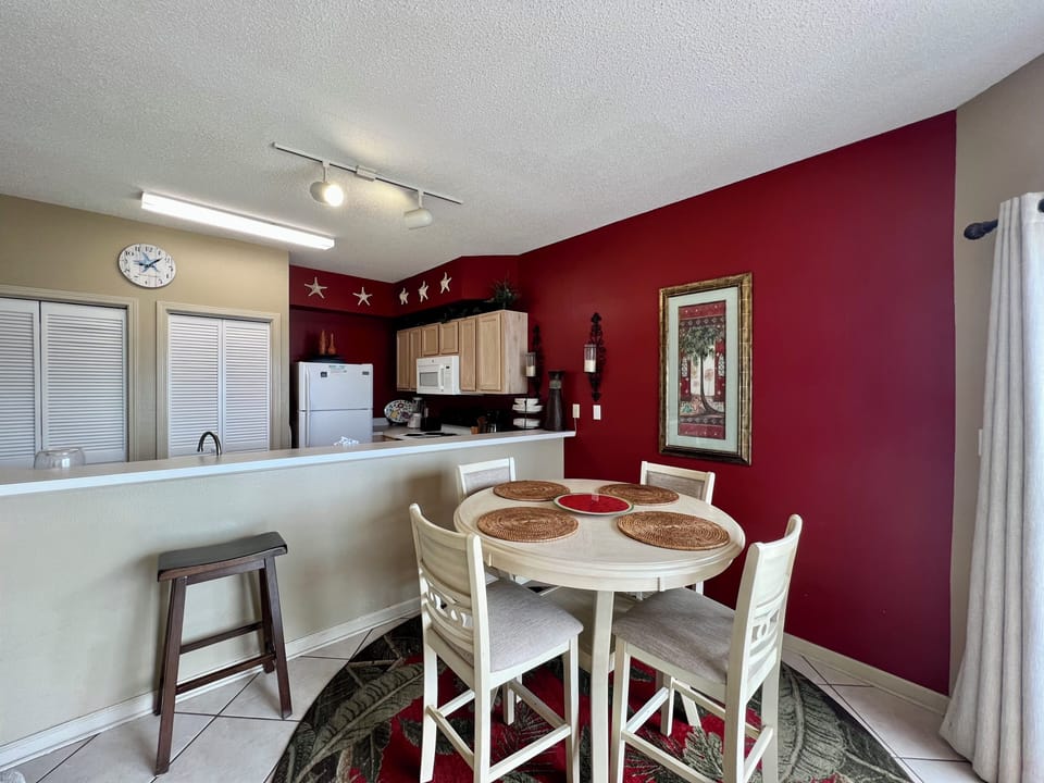 Your open kitchen flows seamlessly into the dining area, perfect for preparing meals and gathering around the elegant white table.