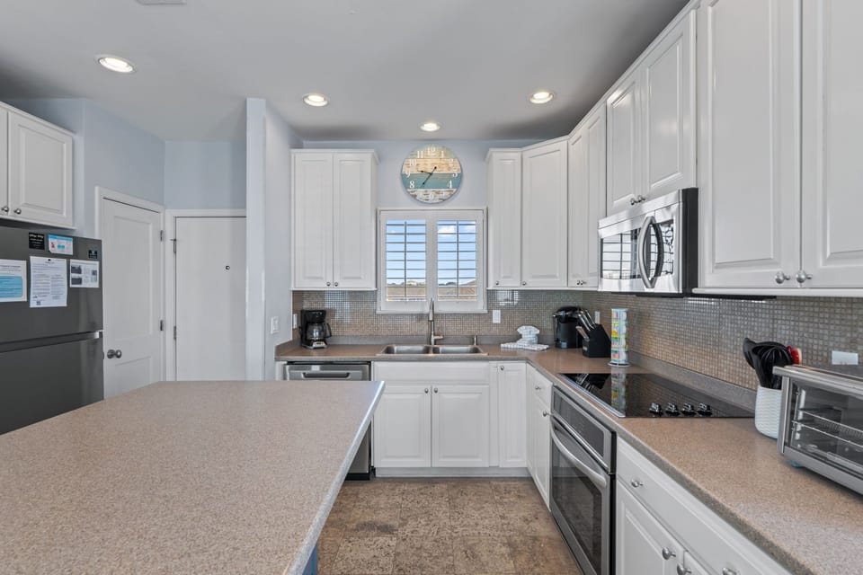 Your spacious kitchen awaits with granite counters, stainless appliances, and everything you need to create memorable meals during your stay.