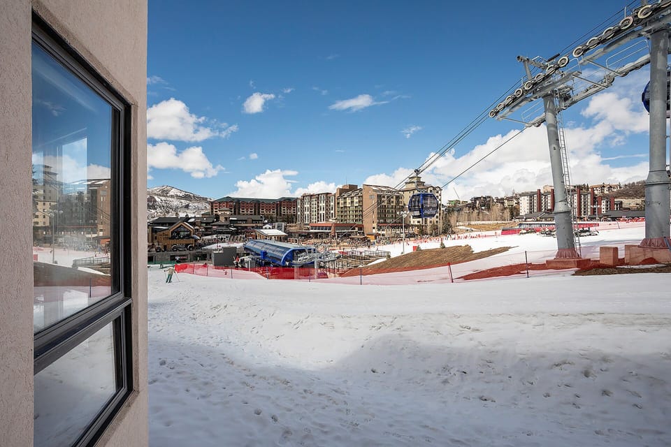 Ski resort village with gondola lift access and mountain views creates the perfect winter base.