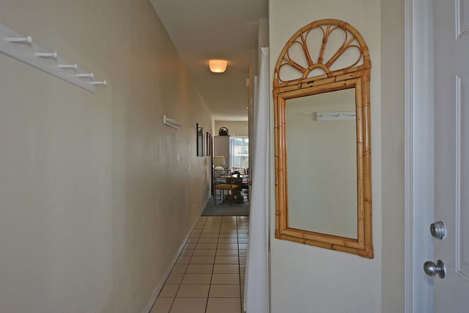 Walk through the bright hallway leading to your comfortable living space, where thoughtful details await your arrival.