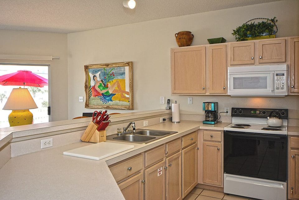 Your fully equipped kitchen awaits with everything needed to prepare meals, from morning coffee to family dinners in this bright, welcoming space.