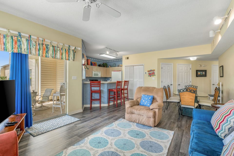 Your bright, cheerful living space features comfortable seating, coastal décor, and an open layout connecting to your kitchen and patio.