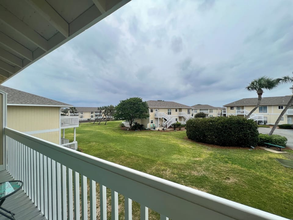 Step onto your private balcony and take in the peaceful courtyard views, where manicured lawns and tropical landscaping create a serene retreat.