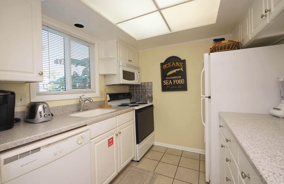 Cook your favorite meals in this bright, fully-equipped kitchen with granite counters, stainless appliances, and charming coastal touches.